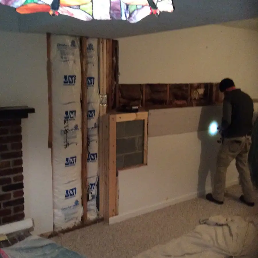 Restoration technician inspecting water damage in Manchester